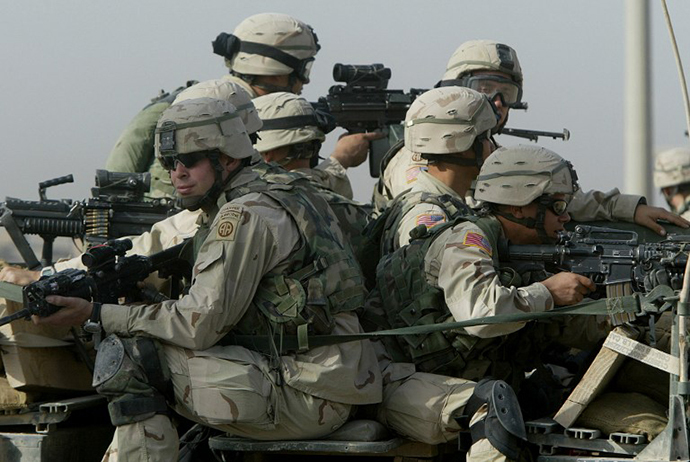 US troops from the 82nd Airborne division take position during a search for a weapons cache in Fallujah, 50 kms (30 miles) west of Baghdad, 07 November 2003. (AFP Photo / Patrick Baz)