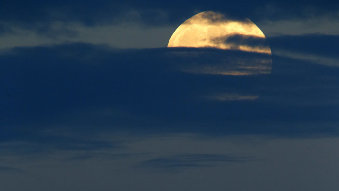 A light aircraft passes beneath the rising full moon off Valletta September 8, 2014.(Reuters/Darrin Zammit Lupi)