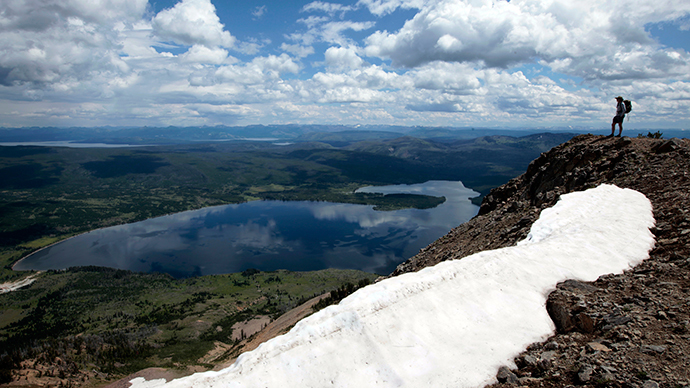 A hiker stands on top of Mount Sheridan, overlooking Heart Lake in the Red Mountains of Yellowstone National Park, Wyoming (Reuters / Lucy Nicholson)