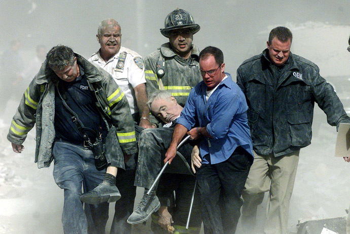 Rescue workers carry fatally injured New York City Fire Depatment Chaplain, Fether Mychal Judge, from one of the World Trade Center towers in New York City, early September 11, 2001. (Reuters/Shannon Stapleton)