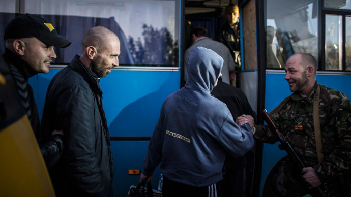 Members of the pro-Russian rebels, who are prisoners-of-war (POWs), enter a bus after being exchanged, north of Donetsk, eastern Ukraine, September 28, 2014.(Reuters / Marko Djurica)