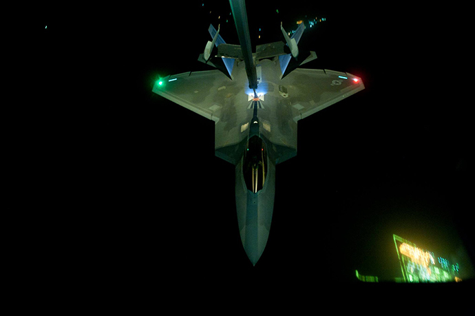 A U.S Air Force KC-10 Extender refuels an F-22 Raptor fighter aircraft prior to strike operations in Syria, Sept. 26, 2014. These aircraft were part of a strike package that was engaging ISIL targets in Syria. (U.S. Air Force photo by Tech. Sgt. Russ Scalf)