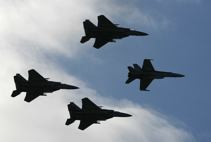 A Royal Australian Air Force F/A-18 Hornet and three US Oregon Air National Guard F-15C Eagle (Reuters/Daniel Munoz)