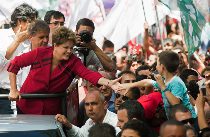 Brazil's President and Workers' Party (PT) presidential candidate Dilma Rousseff touches the hand of a child during a campaign rally in Sao Jose dos Campos, October 3, 2014. (Reuters/Roosevelt Cassio)