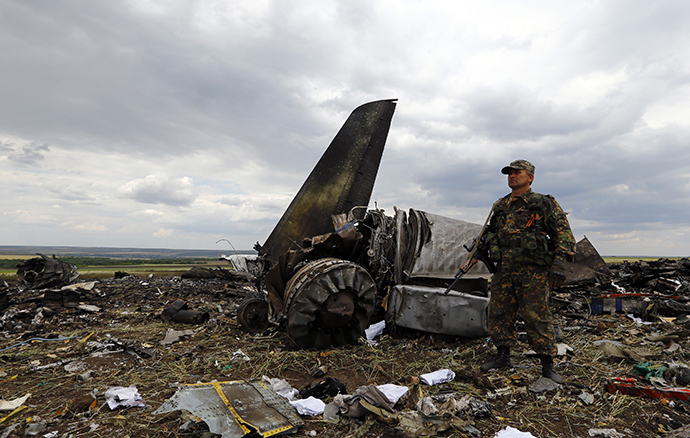 An armed member of self-defenses forces stands guard at the site of the crash of the Il-76 Ukrainian army transport plane in Luhansk June 14, 2014 (Reuters / Shamil Zhumatov)