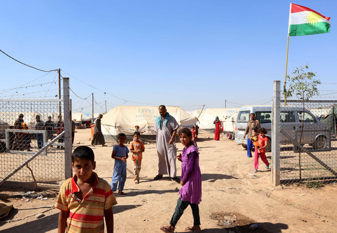 Displaced Iraqis, who had fled their homes after an offensive led by the Islamic State (IS) jihadist group, gather near tents provided by the United Nations High Commission for Refugees (UNHCR) at the Ayden camp, an extension of the larger Aliama camp, in the town of Khanaqin, 160 kms northeast of Baghdad (AFP Photo / Safin Hamed)