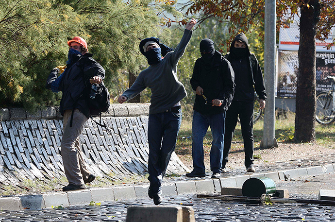 Protesters throw stones as they clash with Turkish riot police during a pro-Kurdish demonstration at the Middle East Technical University (ODTU) in Ankara October 9, 2014 (Reuters / Stringer)