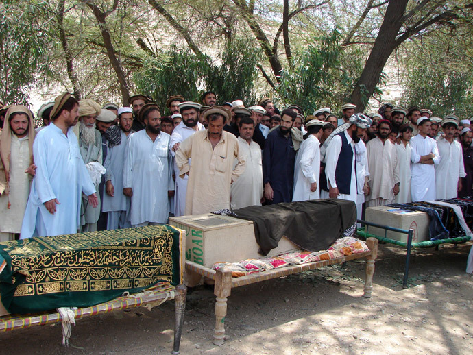 Pakistani tribesmen gather for funeral prayers before the coffins of people allegedly killed in a US drone attack, claiming that innocent civilians were killed during a June 15 strike in the North Waziristan village of Tapi, 10 kilometers away from Miranshah, on June 16, 2011.(AFP Photo / Thir Khan)