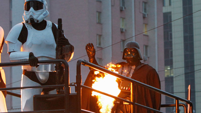 A candidate (R), presenting himself in the character of "Star Wars" villain Darth Vader and representing the Internet Party of Ukraine which runs for parliament, stands on the top a vehicle as he leaves after a meeting with his supporters and voters in Kiev, October 22, 2014.(Reuters / Valentyn Ogirenko )