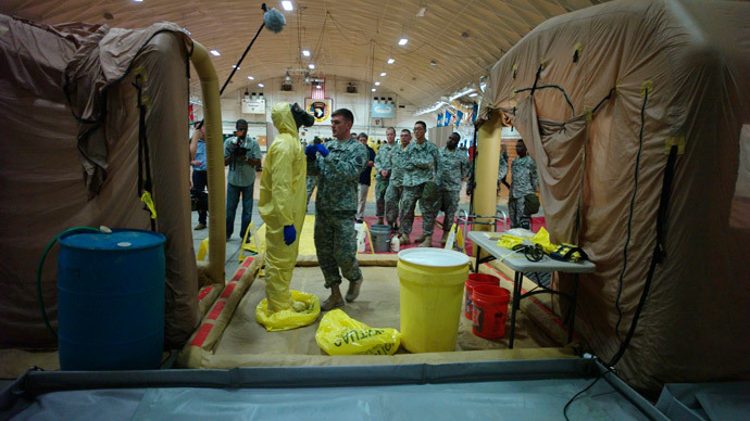 A U.S. Army soldier from the 101st Airborne Division (Air Assault), who are earmarked for the fight against Ebola, goes through decontamination process training before their deployment to West Africa, at Fort Campbell, Kentucky (Reuters / Harrison McClary)