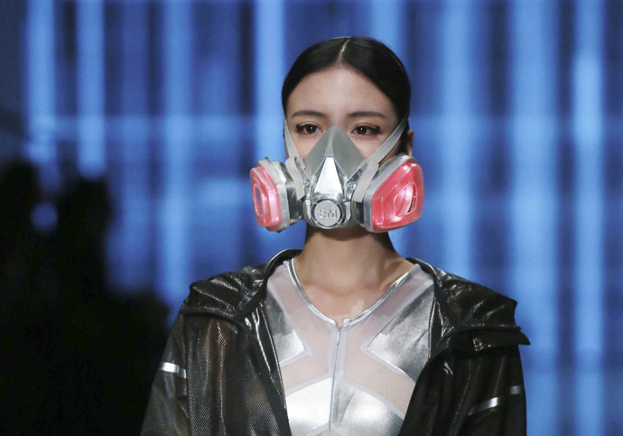 A model wearing a mask presents a creation at the QIAODAN Yin Peng Sports Wear Collection show during China Fashion Week in Beijing, October 28, 2014. (Reuters/Stringer)
