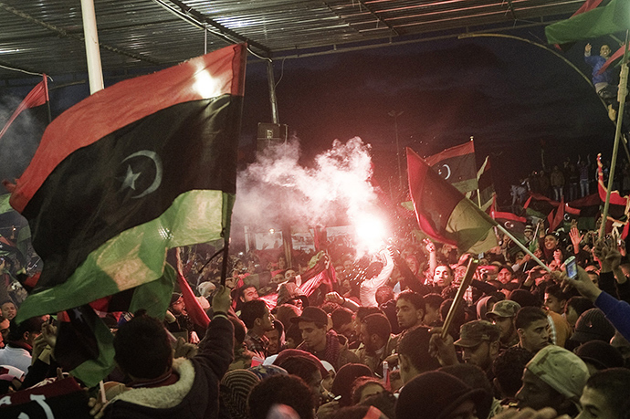 Libyans wave their new national flag as they celebrate the 1st anniversary marking the start of the uprising against Moamer Kadhafi in Freedom Square in the eastern city of Benghazi on February 17, 2012 (AFP Photo)