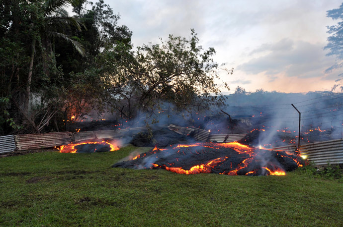 This October 28, 2014 image provided by the US Geological Survey(USGS) shows the lava that has pushed through a fence marking a property boundary above PÄhoa in Hawaii. (AFP Photo)