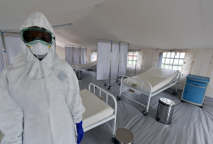 A health worker poses inside a tent in the Ebola treatment unit being preventively set to host potential Ebola patients at the University Hospital of Yopougon, on October 17, 2014. (AFP Photo)