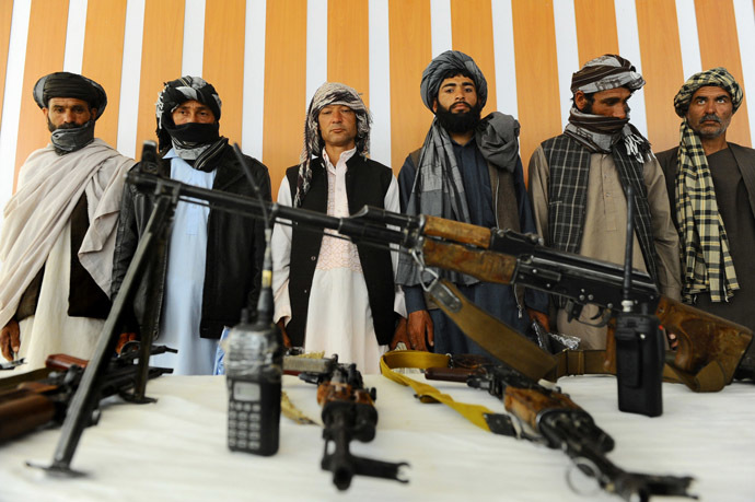 Former Taliban fighters stand with their weapons during a reconciliation process in Herat province (AFP Photo)