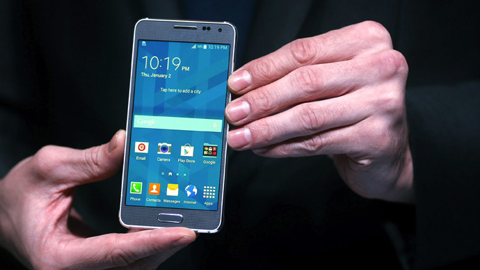 A model holds a Samsung Galaxy Alpha smartphone (Reuters/Beawiharta)