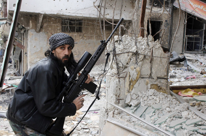 A rebel fighter from the Free Syrian Army holds a position with a Belgium made FAL rifle at a front line in the Salah al-Din neighbourhood of the northern Syrian city of Aleppo (AFP Photo)