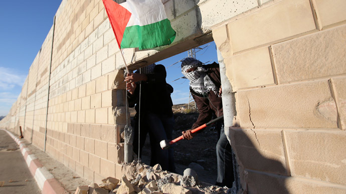 Palestinians break through West Bank barrier to mark Berlin Wall anniversary
