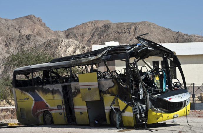 The wreckage of a tour bus that was targeted by a suicide bombing on February 16 is seen in the Egyptian south Sinai resort town of Taba on February 18, 2014. Jihadist group Ansar Beit al-Maqdis today claimed the suicide bombing in Egypt of the tour bus that killed three South Koreans and their local driver. (AFP Photo)