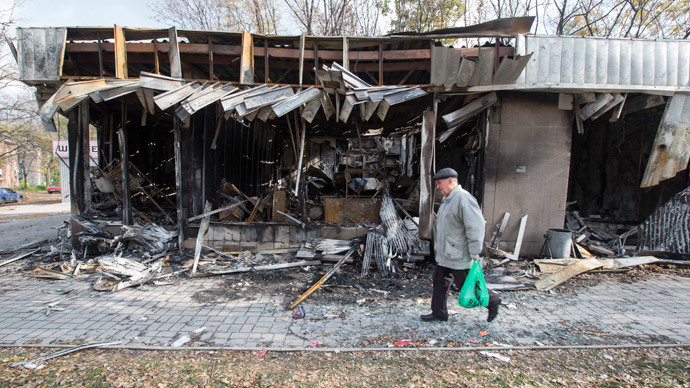 A man walks past shops damaged by recent shellings in Donetsk, eastern Ukraine, October 21, 2014.(Reuters / Shamil Zhumato)