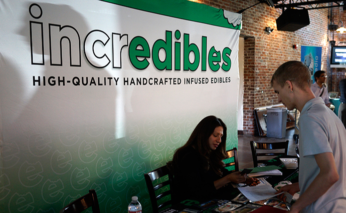 A job applicant (R) talks to a recruiter at the incredibles company booth at the CannaSearch cannabis industry job fair in downtown Denver (Reuters / Rick Wilking)