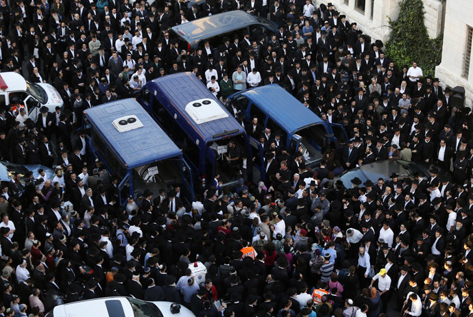 Ultra-Orthodox Jews mourn over the bodies of three of the victims of an attack by two Palestinians on Jewish worshippers killing four Israelis at a synagogue in the Ultra-Orthodox Har Nof neighbourhood in Jerusalem, at the site where the attack took place on November 18, 2014. (AFP Photo/Gali Tibbon)