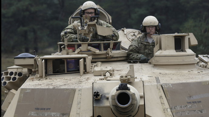 U.S. soldiers deployed in Latvia sit in an Abrams tank during a drill at Adazi military base October 14, 2014. (Reuters / Ints Kalnins)