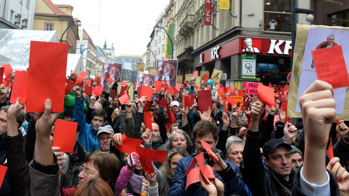 Demonstrators show red cards for Czech President Milos Zeman during a rally to commemorate the 25th anniversary of the Velvet Revolution on November 17, 2014 at Narodni street in Prague. (AFP Photo/Michal Cizek)