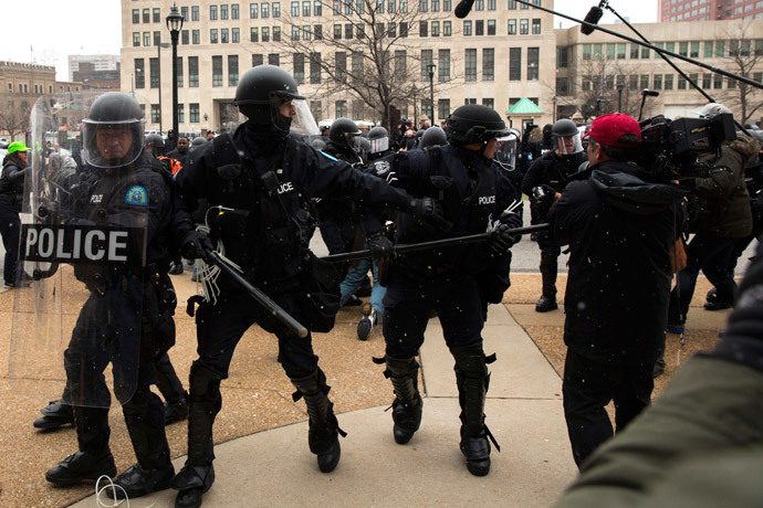 Police officers react to a group marching in protest of the grand jury decision on the killing of Mike Brown as they attempt to force their way into St. Louis City Hall in St. Louis, Missouri November 26, 2014.(Reuters / Lucas Jackson)