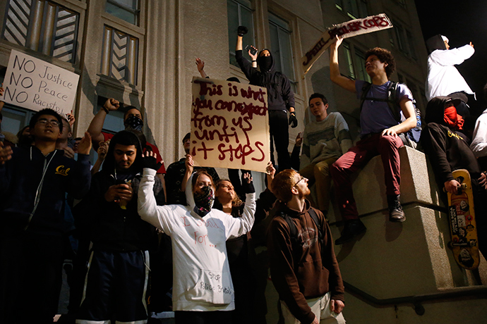 Demonstrators chant outside Berkeley City Hall during a march against the New York City grand jury decision to not indict a police officer in the death of Eric Garner, in Berkeley, California December 7, 2014 (Reuters / Stephen Lam)