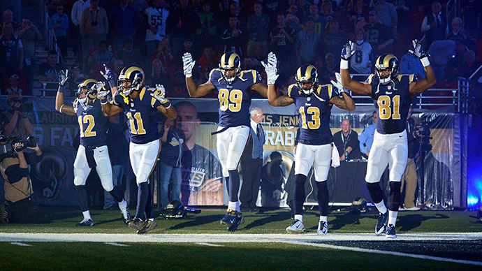 St. Louis Rams wide receiver Stedman Bailey (12) and wide receiver Tavon Austin (11) and tight end Jared Cook (89) and wide receiver Chris Givens (13) and wide receiver Kenny Britt (81) put their hands up to show support for Michael Brown before a game against the Oakland Raiders at the Edward Jones Dome (Reuters / Jeff Curry)