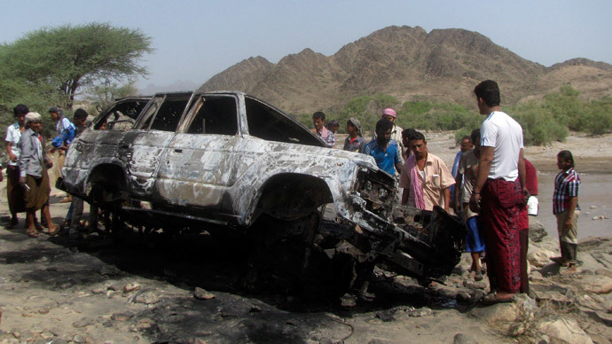 People gather at the site of a drone strike on the road between Yafe and Radfan districts of the southern Yemeni province of Lahj August 11, 2013.(Reuters / Stringer)