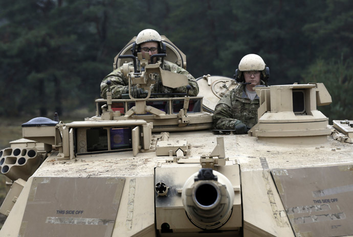 U.S. soldiers deployed in Latvia sit in an Abrams tank during a drill at Adazi military base October 14, 2014. (Reuters/Ints Kalnins)