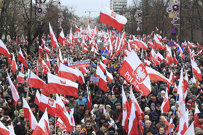 People carry Polish flags during a demonstration march in Warsaw December 13, 2014. (Reuters/Jacek Marczewski/Agencja Gazeta)