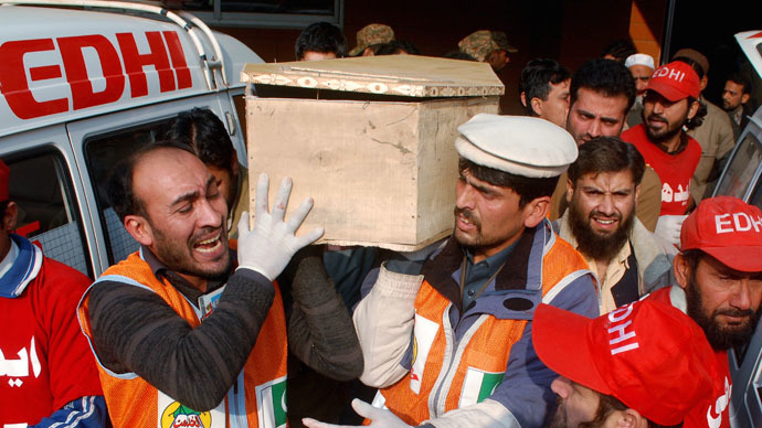 Rescue workers and family members carry the coffin of a student, who killed during an attack by Taliban gunmen on the Army Public School, in Peshawar, December 16, 2014. (Reuters/Khuram Parvez)