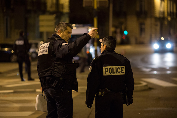 Policemen gesture on December 21, 2014 in Dijon on the site where a driver shouting "Allahu Akbar" ("God is great") ploughed into a crowd injuring 11 people, two seriously, a source close to the investigation said (AFP Photo / Arnaud Finistre)