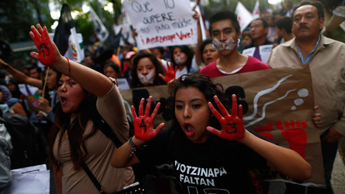 Activists gesture during a march to demand justice for the 43 missing students from Ayotzinapa Teacher Training in Mexico City December 26, 2014.(Reuters / Edgard Garrido)