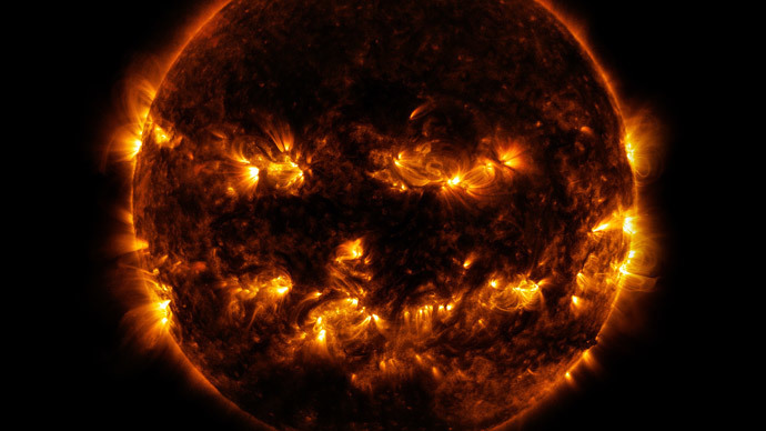 This NASA image obtained October 10, 2014 shows active regions on the sun as they gave it the appearance of a jack-o'-lantern.(AFP Photo / NASA)