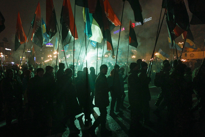 Activists of the Svoboda (Freedom) and Right Sector Ukrainian nationalist parties hold flags as they take part in a rally to mark the 106th birth anniversary of Stepan Bandera, one of the founders of the Organization of Ukrainian Nationalists (OUN), in Kiev January 1, 2015. (Reuters / Valentyn Ogirenko)