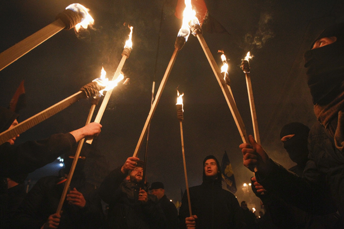 Activists of the Svoboda (Freedom) and Right Sector Ukrainian nationalist parties hold torches as they take part in a rally to mark the 106th birth anniversary of Stepan Bandera, one of the founders of the Organization of Ukrainian Nationalists (OUN), in Kiev January 1, 2015. (Reuters / Valentyn Ogirenko)