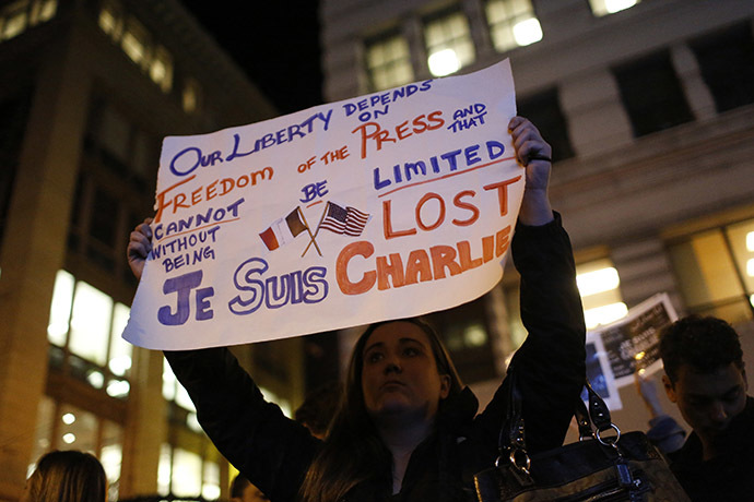 Tara Manning, an American who works for a French-American Company, holds a sign as people gather for a vigil outside the Consulate General of France to pay tribute to the victims of an attack on satirical magazine Charlie Hebdo in Paris, in San Francisco, California January 7, 2015. (Reuters/Stephen Lam)