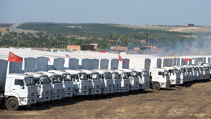Trucks of Russian humanitarian convoy are parked in a field outside the town of Kamensk-Shakhtinsky in Rostov region, some 30 km from the Russian-Ukrainian border, Russia (AFP Photo / Dmitry Serebryakov)