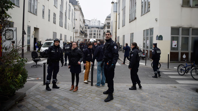 Police forces gather in street outside the offices of the French satirical newspaper Charlie Hebdo in Paris on January 7, 2015.(AFP Photo / Martin Bureau)