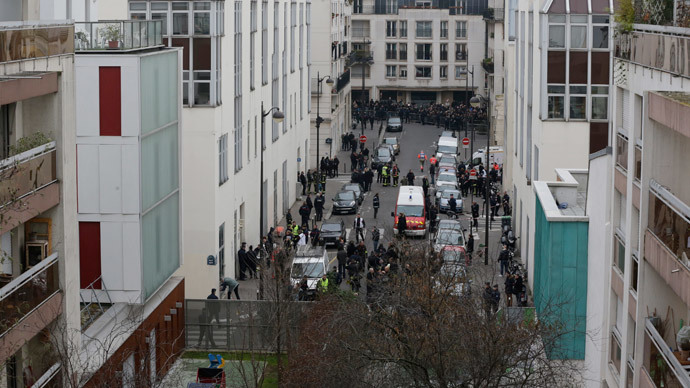 General view of the street where police and fire fighters work in front of the Paris offices of Charlie Hebdo, a satirical newspaper, after a shooting January 7, 2015.(Reuters / Philippe Wojazer )