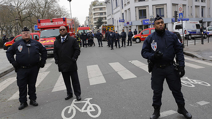 Policemen work at the scene after a shooting at the Paris offices of Charlie Hebdo January 7, 2015. (Reuters/Youssef Boudlal)