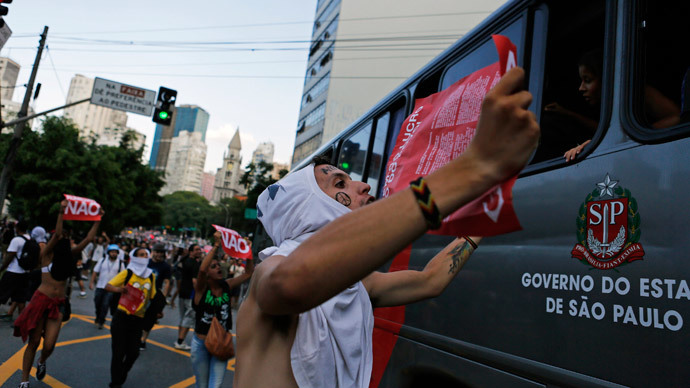 Demonstrators shout slogans in front of a bus during a protest against fare hikes for city buses, subway and trains in Sao Paulo January 9, 2015. (Reuters / Nacho Doce)