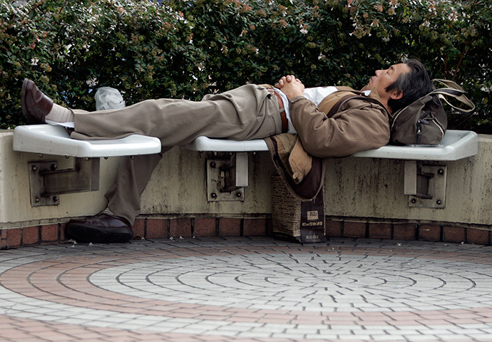 A man takes a nap on a bench in Tokyo (Reuters / Yuriko Nakao)