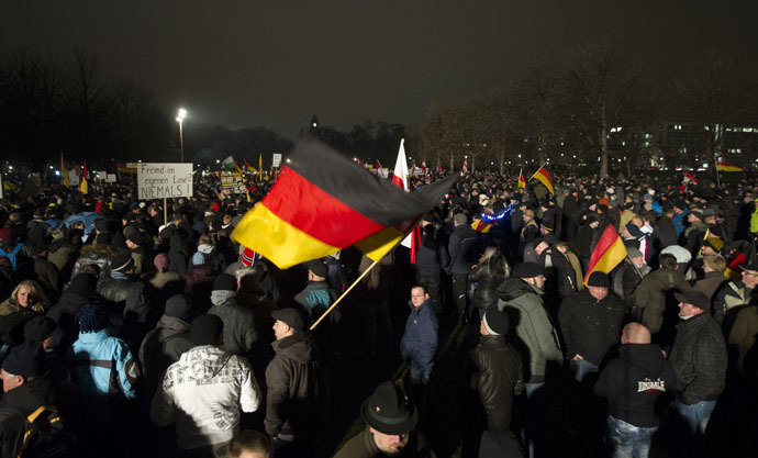 Demonstrators wave with German national flags during a rally by a mounting right-wing populist movement called Pegida on January 5, 2015 in Dresden, eastern Germany. (AFP Photo/Robert Michael)