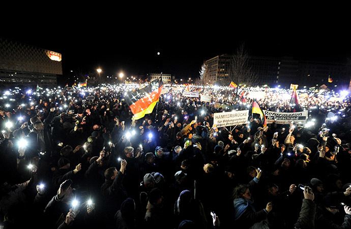 Sympathizers of German anti-immigration movement PEGIDA (Patriotic Europeans Against the Islamisation of the Occident) attend their twelfth march in Dresden, eastern Germany on January 12, 2015. (AFP Photo/Robert Michael)