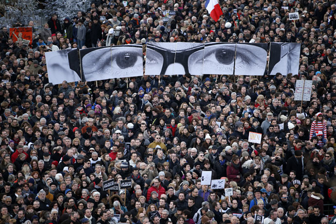 eople hold panels to create the eyes of late Charlie Hebdo editor Stephane Charbonnier, known as "Charb", as hundreds of thousands of French citizens take part in a solidarity march (Marche Republicaine) in the streets of Paris January 11, 2015. (Reuters/Charles Platiau)